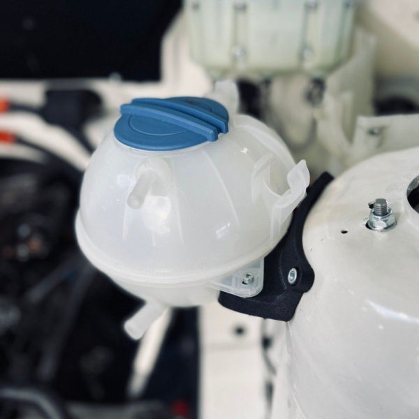 Black PA-GF 3D printed expansion tank bracket fitted with the coolant tank on a BMW E46 strut tower
